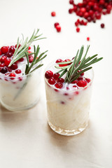 Perfect christmas cocktail: coconut margarita with cranberries and rosemary. Minimalistic concept. Linen cloth and white background.