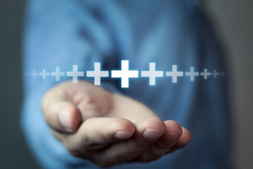 Man showing plus sign.