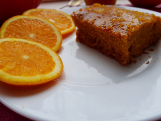 Naklejka na ściany i meble A piece of a homemade orange cake for breakfast, closeup