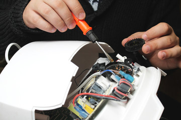The technician hold the screwdriver for repairing the computer. the concept of computer hardware, repairing, upgrade and technology.