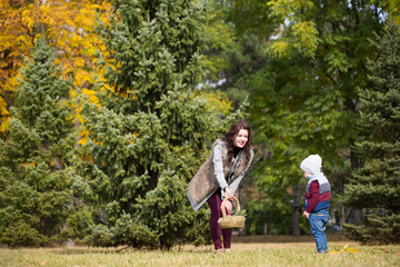 Naklejka na ściany i meble mother with her son walks in the autumn park