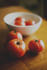 red tomatoes on wooden table