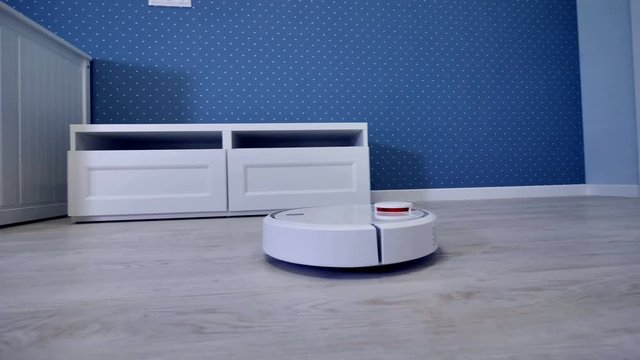 A robotic vacuum cleaner starts its routine from the door. 