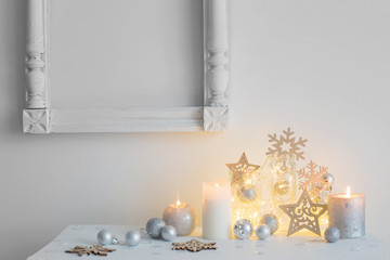 Christmas decoration with candles on background  white wall
