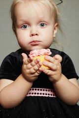 funny child girl eats a cake