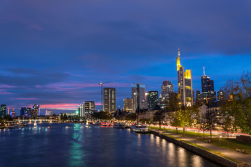 Fototapeta na wymiar The skyline of Frankfurt with the river Main during blue hour