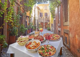  A summer  dinner .Pasta , pizza  and homemade food arrangement  in a restaurant  Rome   .Tasty and authentic Italian food. © natalia_maroz