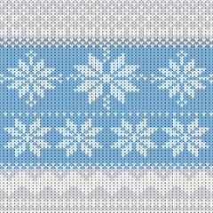 Knitted winter background with snowflakes