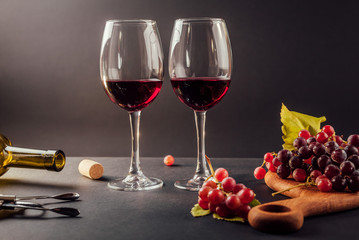 Two glasses of wine with grapes