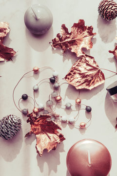 Fall Rose Gold Leaves And Candles With Woman Accessories On White Marble Table. 