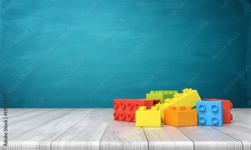 Poster 3d rendering of a toy building blocks lying in a colorful pile over a wooden desk on a blue backgrou