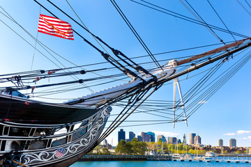Boston skyline framed by the USS Constitution, a historic battleship in American history