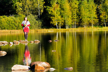 Beautiful woman spending time in park during autumn season