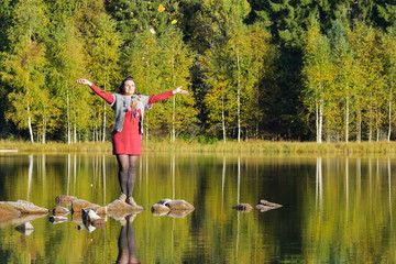 Fototapeta na wymiar Beautiful woman spending time in park during autumn season