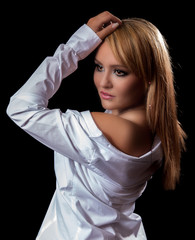 Young blonde woman in white top is posing