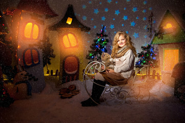 Obraz na płótnie Canvas Little beautiful girl playing in the winter yard