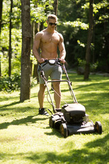 Man athlete mow lawn with grass cutter