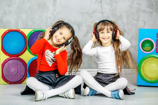 The two children laugh and listen to the songs in the headphones. Concept music, radio, dance, life stroke, rest.