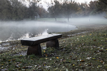 empty bench in the morning fog
