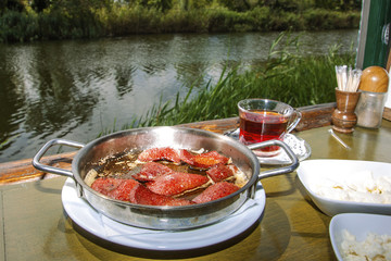 Fried sausage and black tea by the river