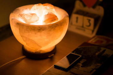 Salt lamp on the wooden table