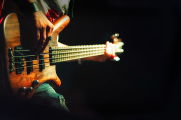 Bassist pop rock during a performance at a concert - obrazy, fototapety, plakaty