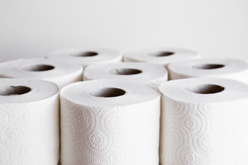 White toilet paper rolls on the gray background. Hygiene concept.