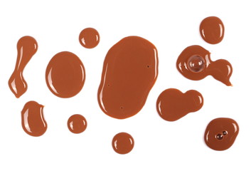 Spilled chocolate milk puddle isolated on white background, top view