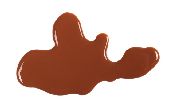 Spilled chocolate milk puddle isolated on white background, top view