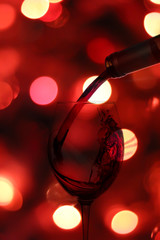 a splash of wine poured into a glass in the background with a gl