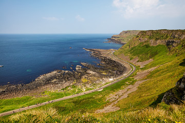 Thousands of tourists visiting Giant's Causeway in County Antrim of Northern Ireland, a World Heritage Site by UNESCO containing about 40000 interlocking basalt columns from ancient volcanic eruption