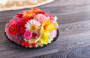 floral arrangement of autumn flowers on a plate