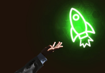 Man palm presenting Rocket web icon as technology concept