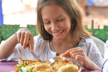 girl eating meat pockets