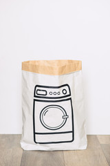 Paper craft package with a picture of the washing machine on the floor against the white background.  Washbasin bag.