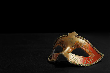 Golden Mardi Gras or Carnival mask isolated on a black background