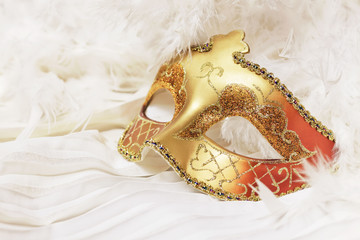 Golden Mardi Gras or Carnival mask on a white background