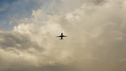 Passenger airplane taking off at sunset against the background of a very beautiful clouds.