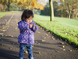 Baby girl playing at Autumn outdoor park