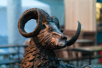 The metallic head of ram. The statue head aries.