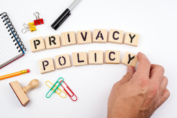 privacy policy. Wooden letters on a white background.