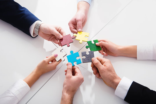 Teamwork of partners. Concept of integration and startup with puzzle pieces