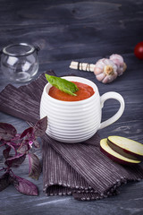 Homemade vegetarian soup puree with eggplant, tomatoes, zucchini and garlic on a dark background