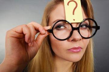 Woman having question mark on forehead thinking
