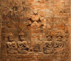 Fototapeta na wymiar Rare brick bas-relief representig Lakshmi, consort of Vishnu, in the sanctuary of Prasat Kravan In Angkor, Cambodia. Temple is dedicated to Vishnu.
