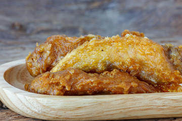 fried chicken wings on a wooden background.

