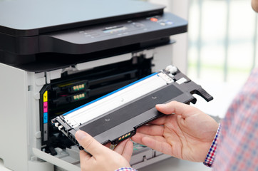 Man replacing toner in laser printer