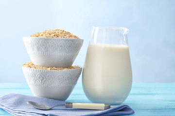 Composition with oatmeal flakes and milk on light background