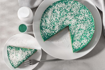 Tasty spirulina cheesecake on table
