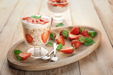 Delicious dessert with fresh strawberry on table